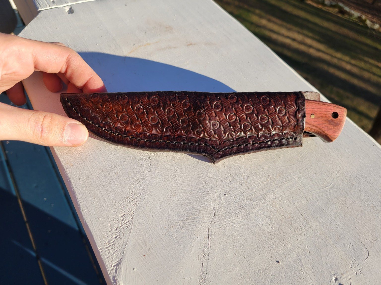 Hand-tooled brown leather knife sheath
